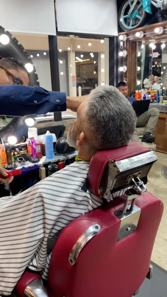 A client mid cut in the barber chair at Aldostylist