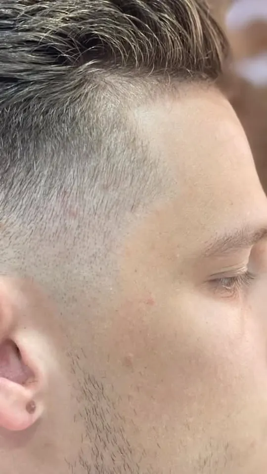 Close detail of a skin fade blended to the ear