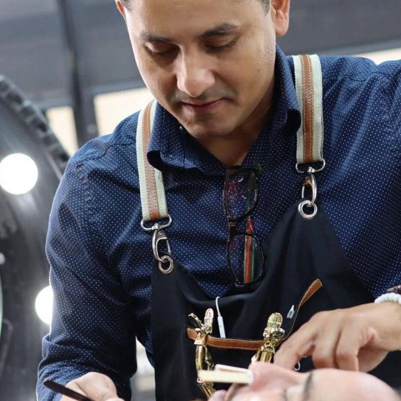 Aldo working a straight razor along a client's jawline