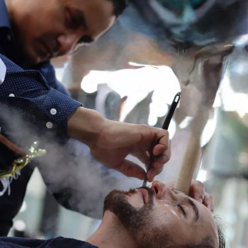 Hot towel steam rising during a Royal Shave at Aldostylist
